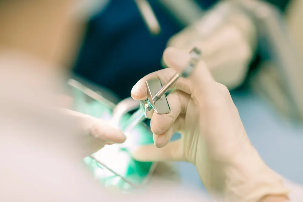 Clinician preparing for an oral surgical procedure